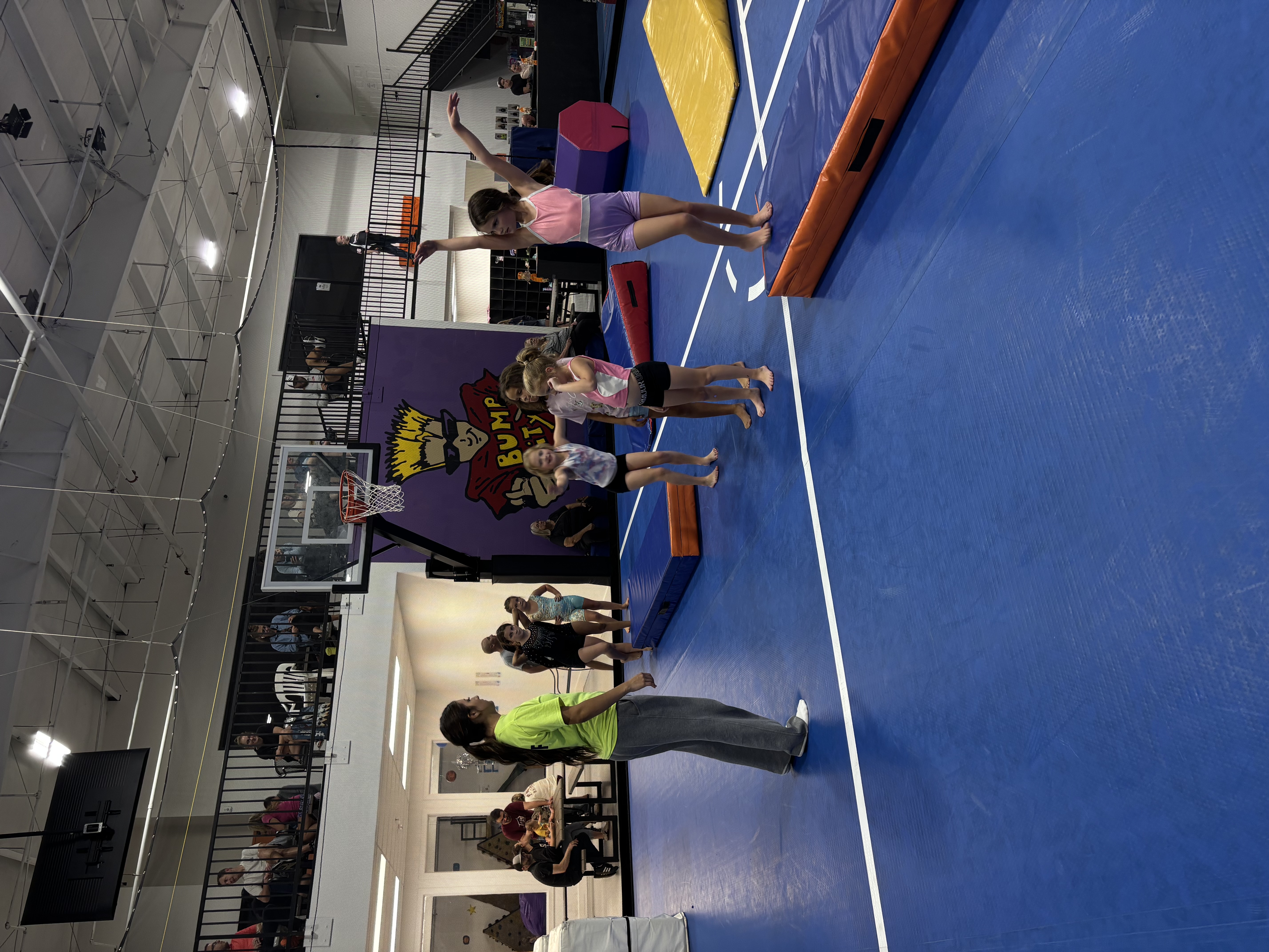 Gym activity with families visible on the viewing mezzanine